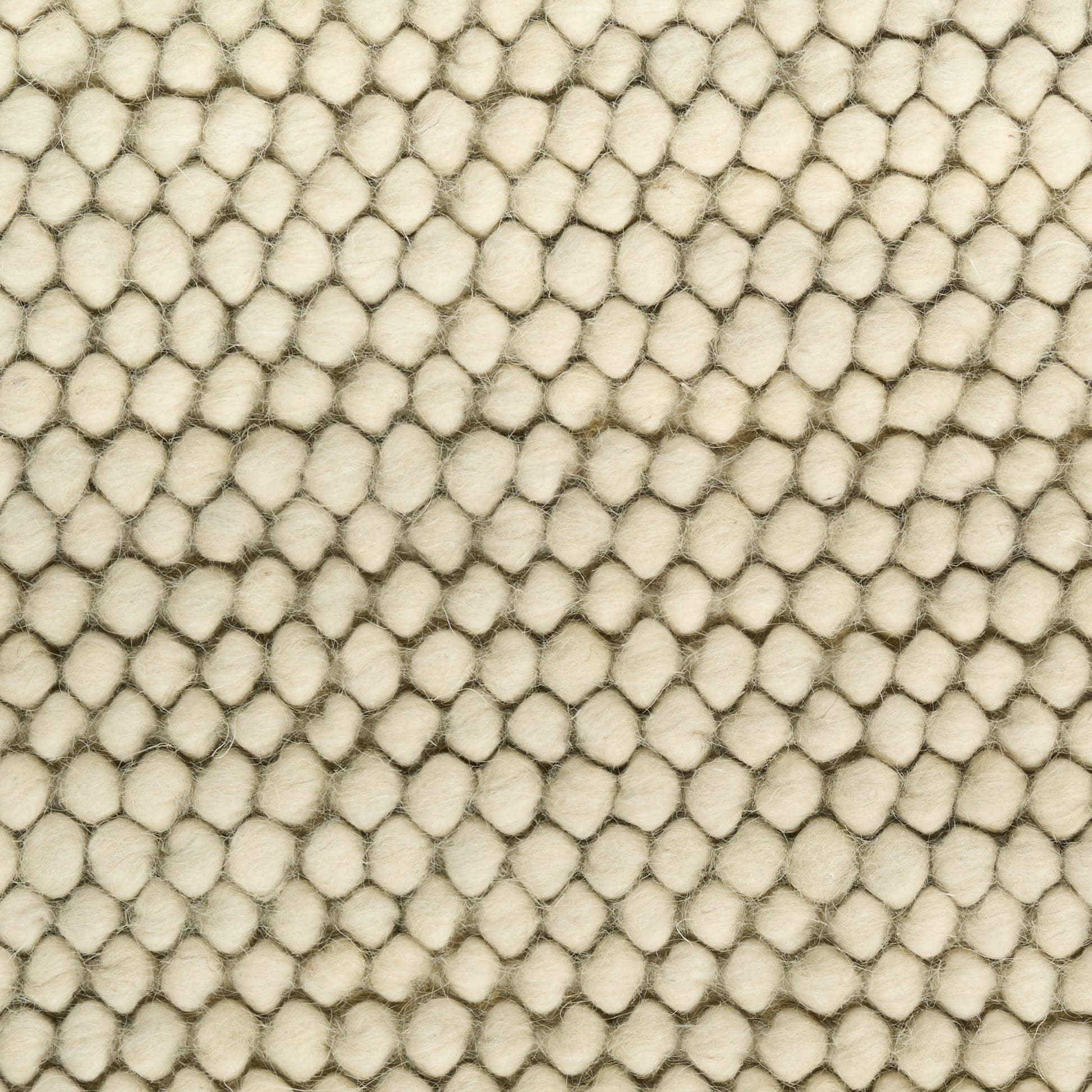 Cream pebble-textured rug with tiny rounded bumps arranged in a dense grid.