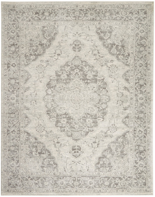 Light gray-beige Persian-style rug with central medallion and ornate border; distressed vintage look.