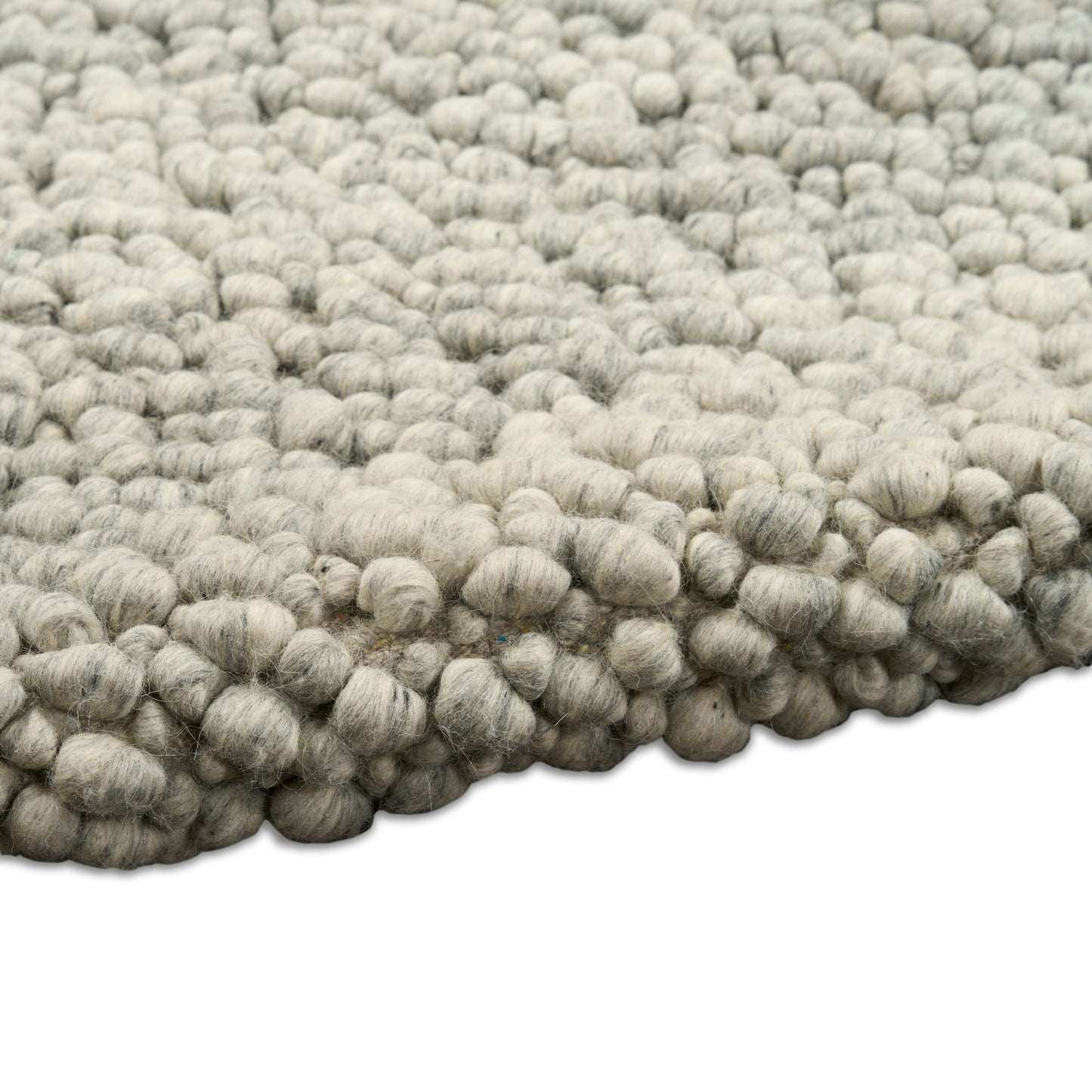 Light gray wool boucle rug with chunky knobby loops, dense textured surface for cozy floor decor.