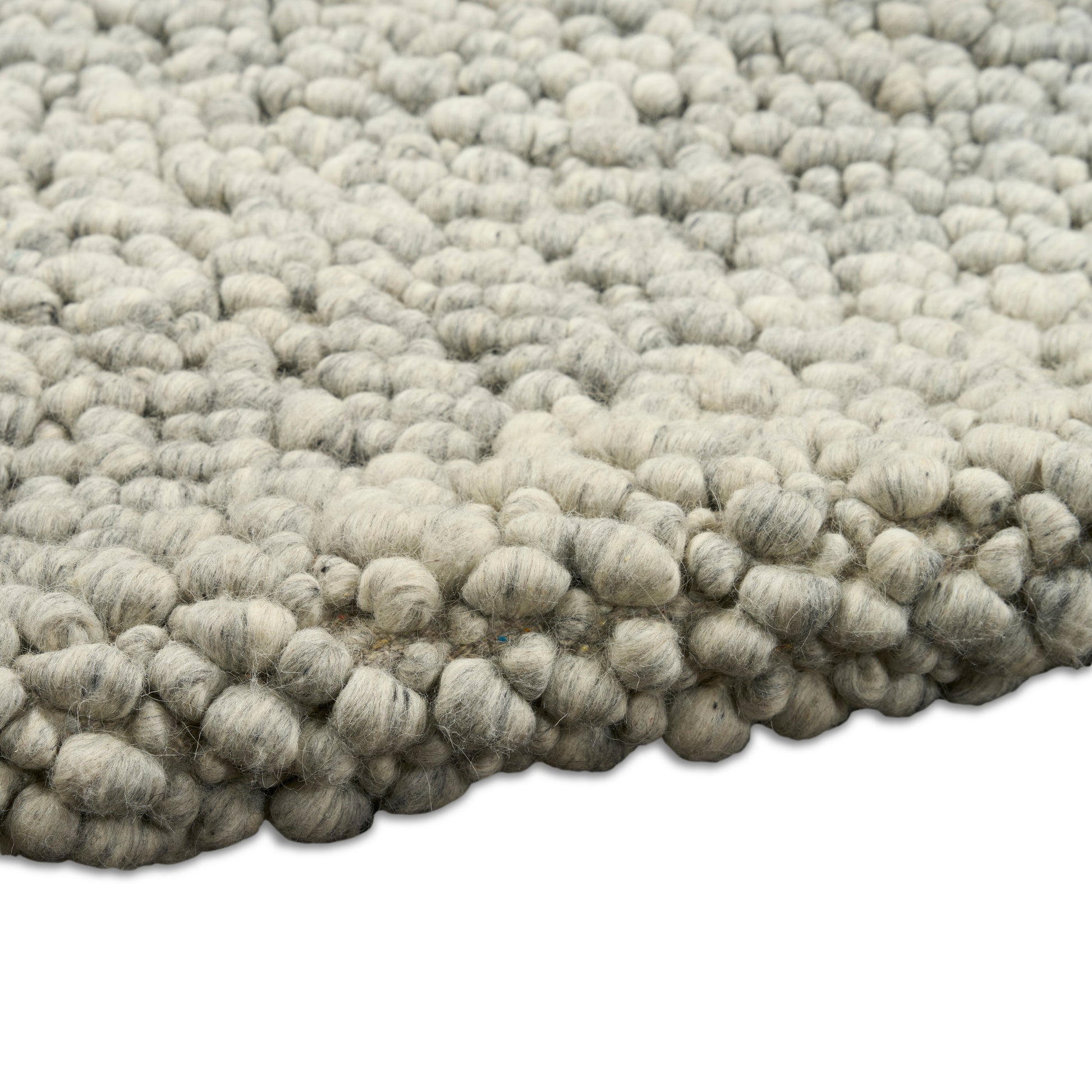 Light gray wool boucle rug with chunky knobby loops, dense textured surface for cozy floor decor.
