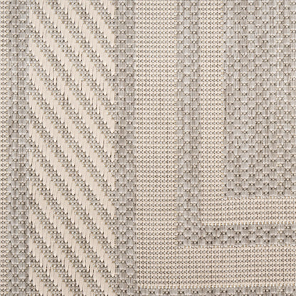 Cream woven fabric with diagonal chevron stripe and dotted grid texture, framed by a geometric border.
