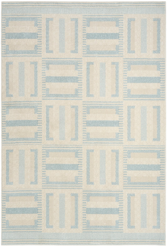 Cream woven rug with pale blue geometric grid of rectangles; modern coastal-inspired design.