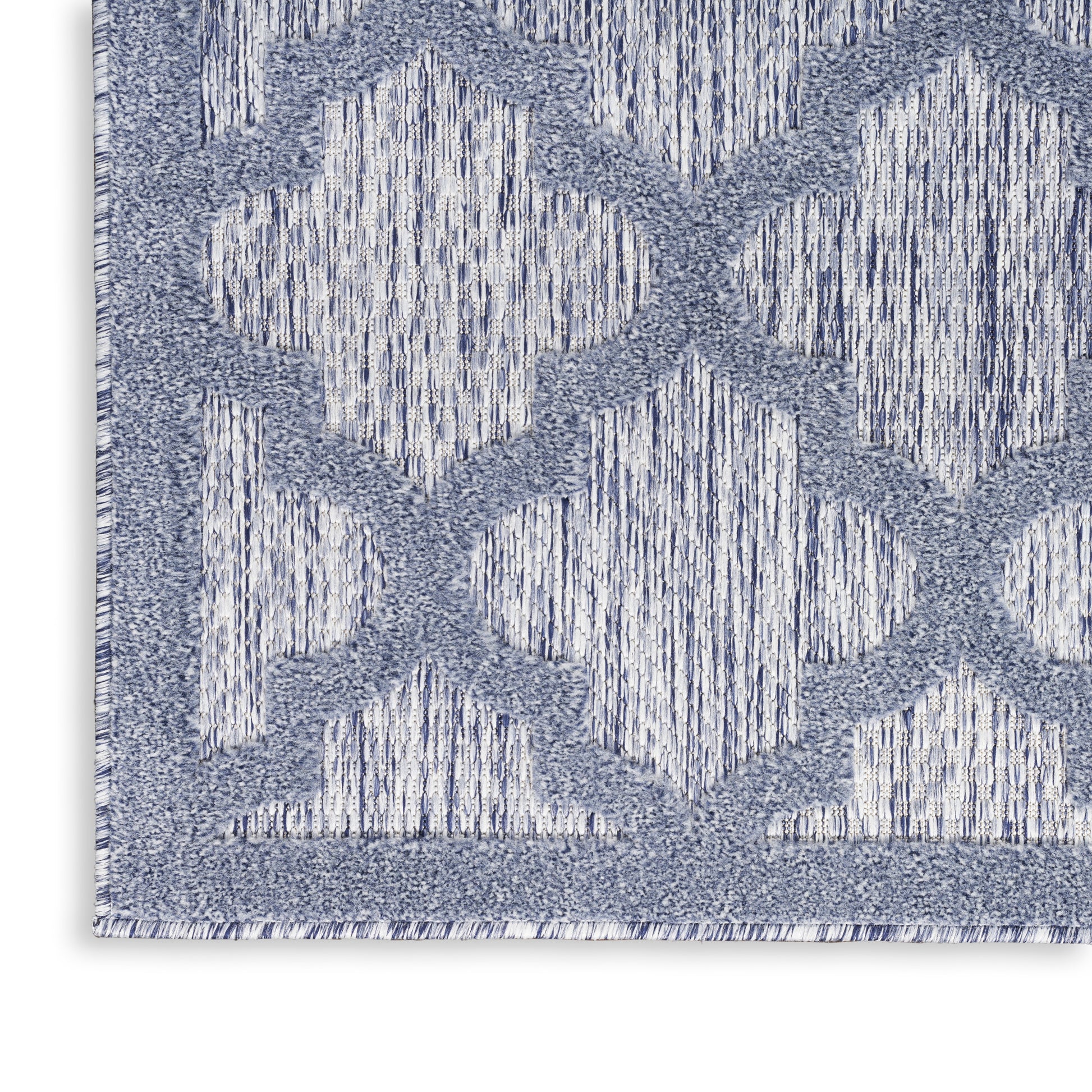 Blue and white geometric area rug with diamond trellis pattern and woven texture.