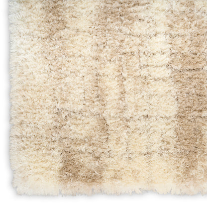 Cream-beige shag rug with plush high-pile fibers in cream and tan tones; ultra-soft and fluffy.