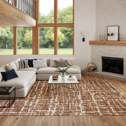 Bright living room with large wood-framed windows, beige sectional sofa, glass-top coffee table, and a stone fireplace.