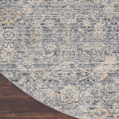 Blue-gray oriental vintage round rug, 8' diameter, with cream and pale-yellow floral medallions on a dark wood floor.
