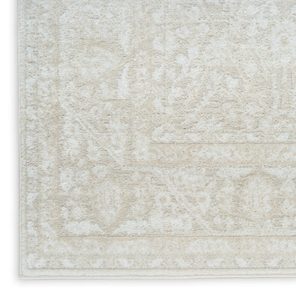 Beige cream patterned area rug with subtle damask motifs and light border; textured, plush pile.