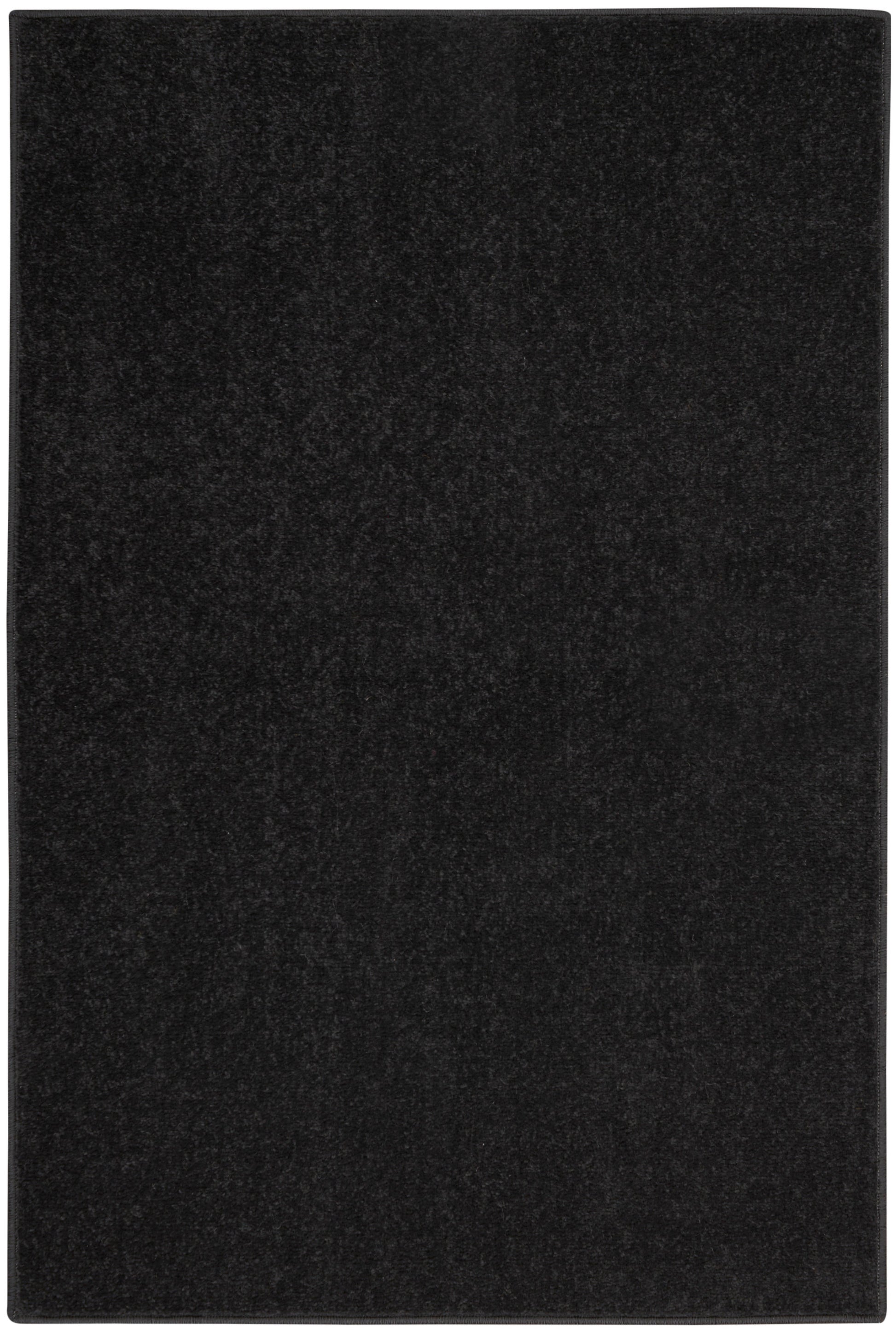 Black rectangular outdoor rug with a soft textured surface.