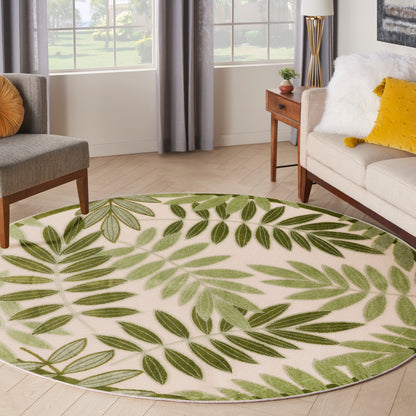 5' round outdoor rug with a green leafy palm pattern on beige.