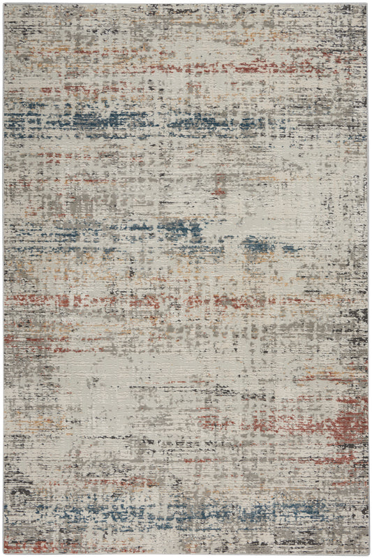 Rectangular area rug with an abstract, distressed pattern in beige base and blue, rust, gray brush-stroke accents.