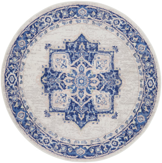 Round blue and white oriental rug with intricate central medallion and ornate floral border.