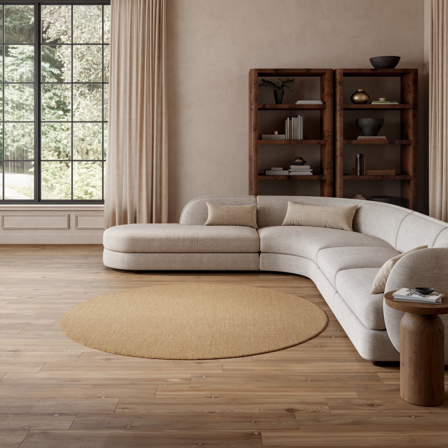 Neutral beige round jute rug, 8' diameter, on wood floors in a sunlit living room.