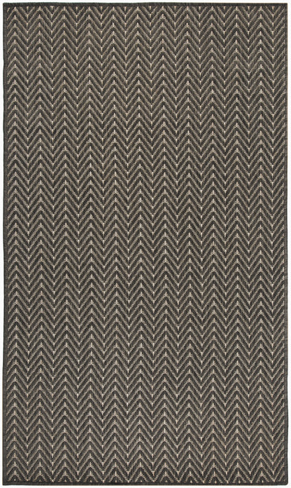 Rectangular woven rug in black & cream with a bold chevron zigzag pattern, textured geometric style.