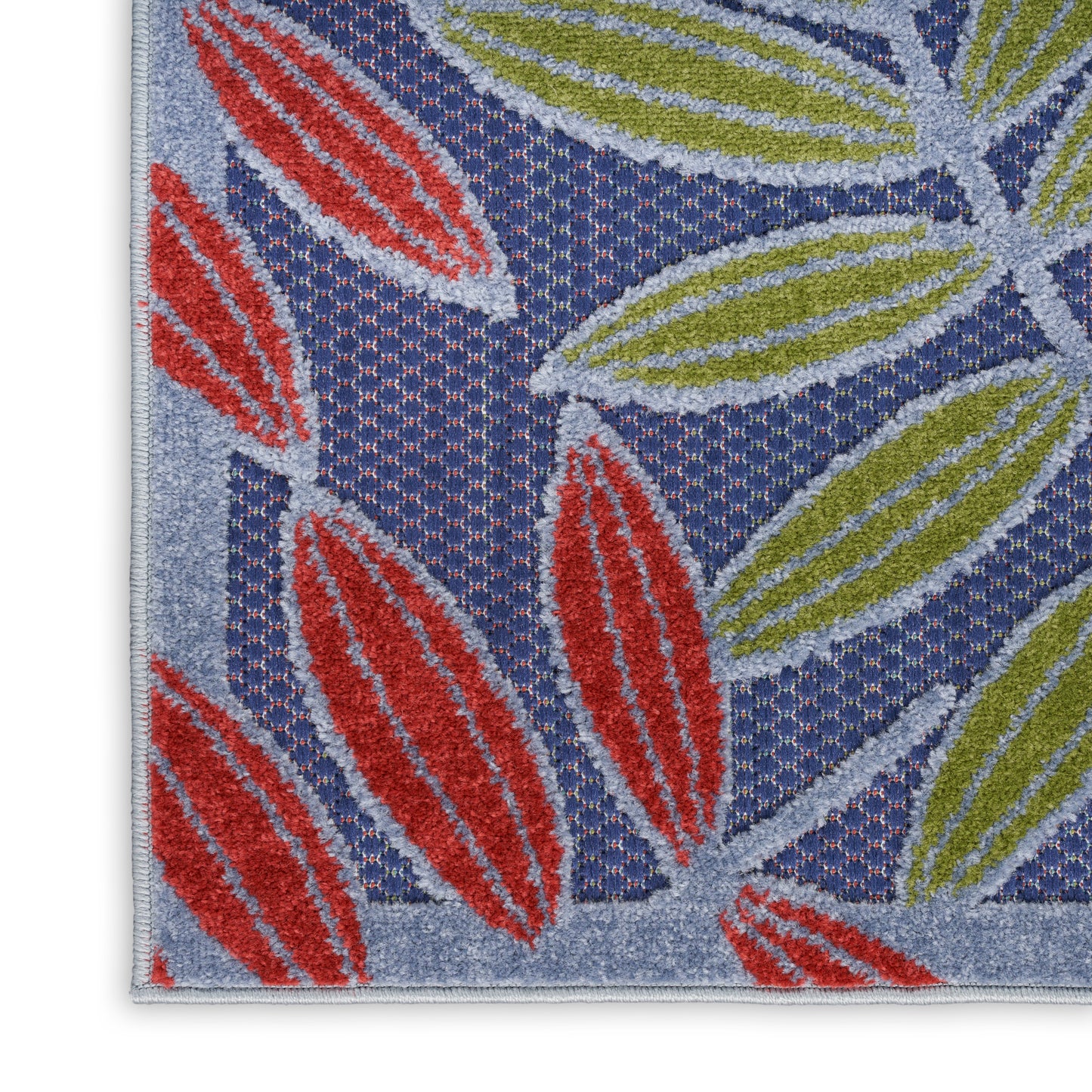 Blue woven rug with red and olive-green leaf motifs and a light gray border.