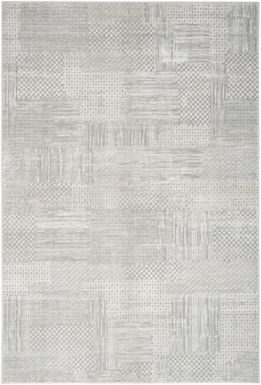 Light gray patchwork area rug with subtle woven textures; modern neutral decor for living room or bedroom.