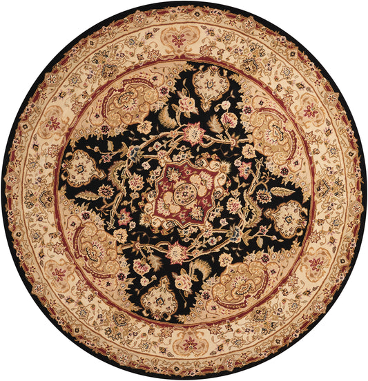 Round Persian-style rug with black center field, ivory-beige floral motifs and a detailed red border.