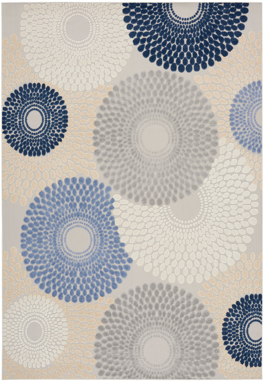 Geometric rug featuring large circular sunburst motifs in navy, blue, gray and beige.