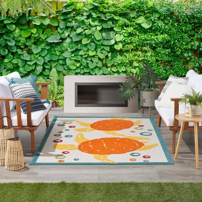 Coastal rug with teal border and orange crab motif.