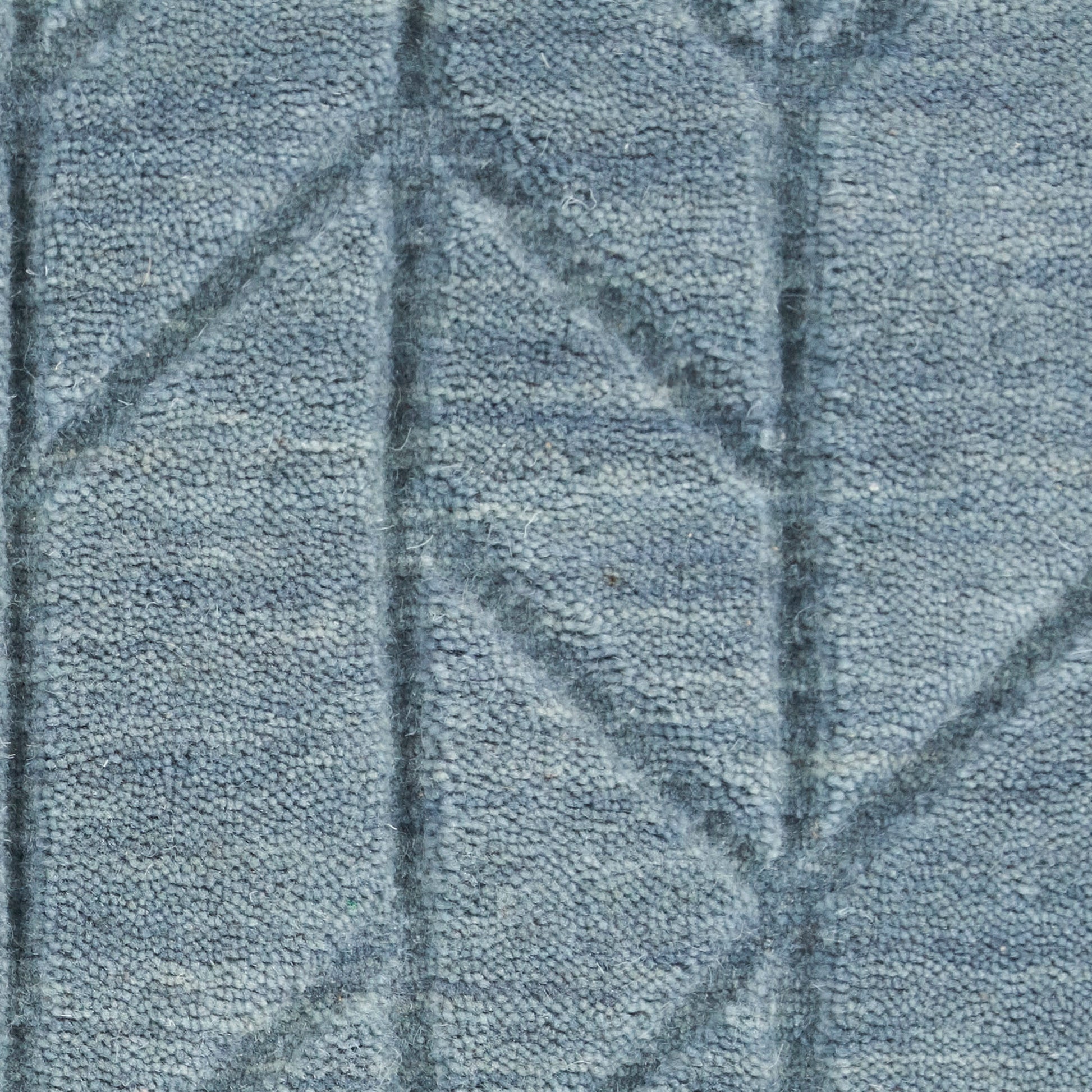 Blue-gray plush terrycloth rug with stitched geometric chevrons; soft, cozy rug material.