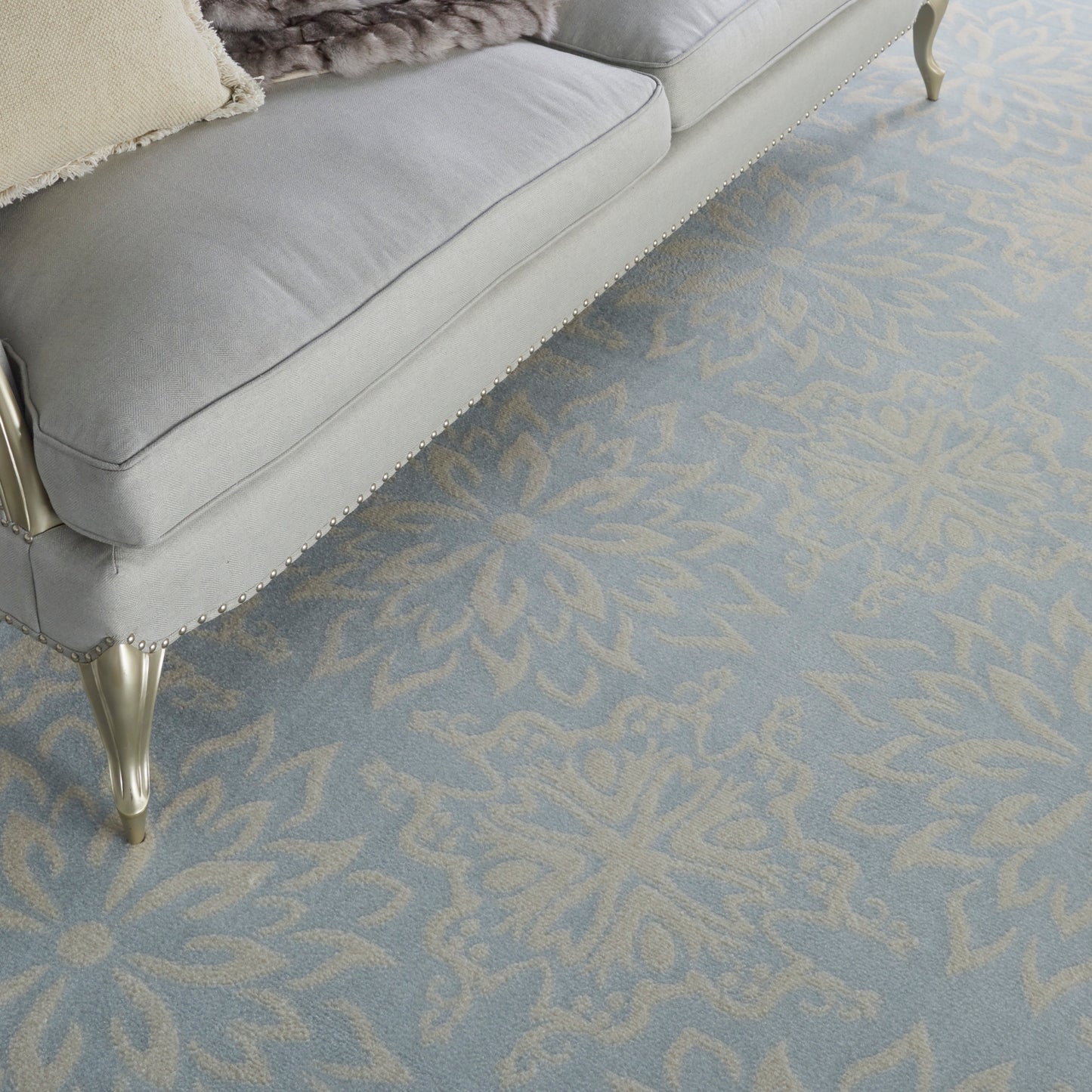 Soft gray-blue rug with a pale blue floral pattern, 8' x 10'.
