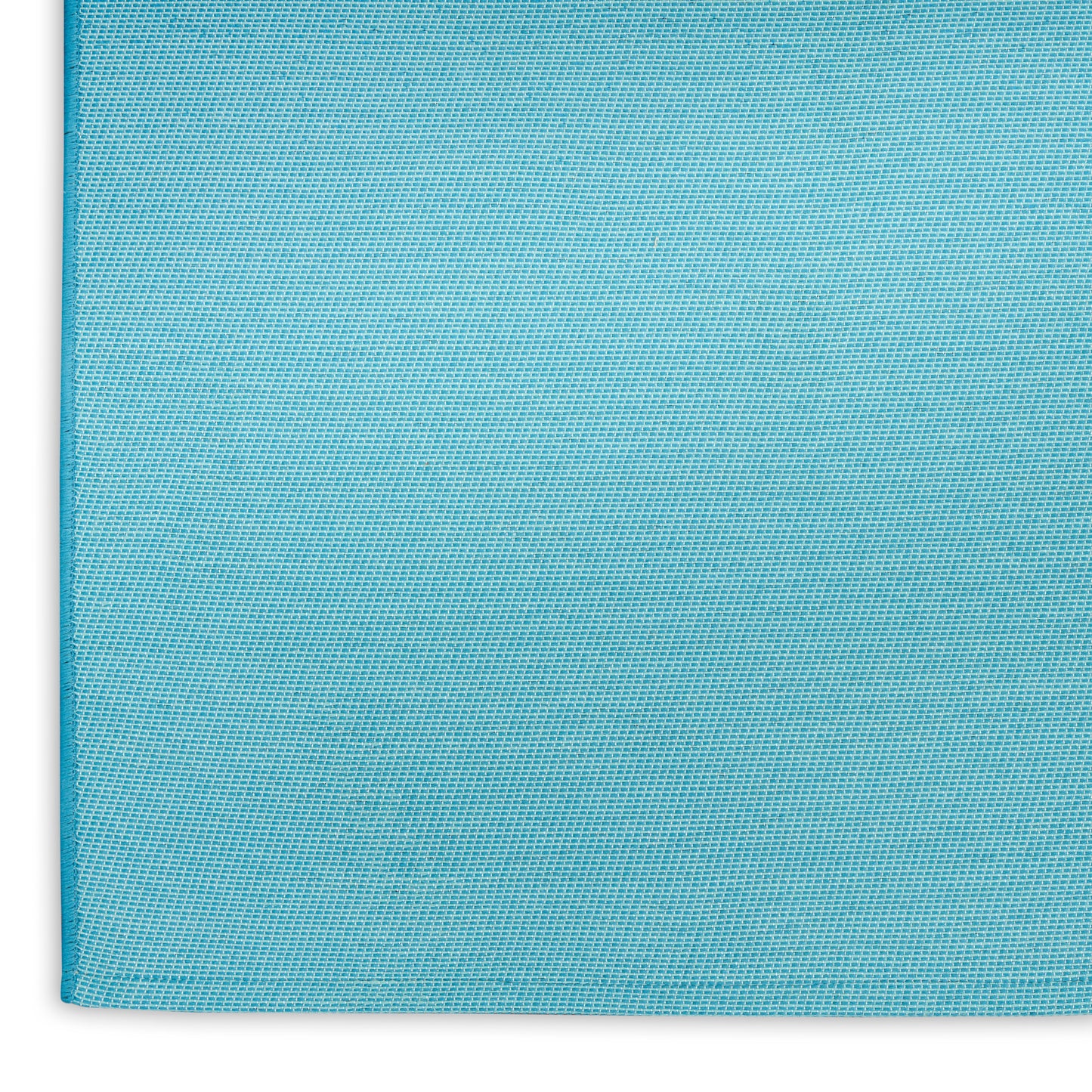 Turquoise blue rug close-up with visible weave and edge seam; suitable for coastal decor.