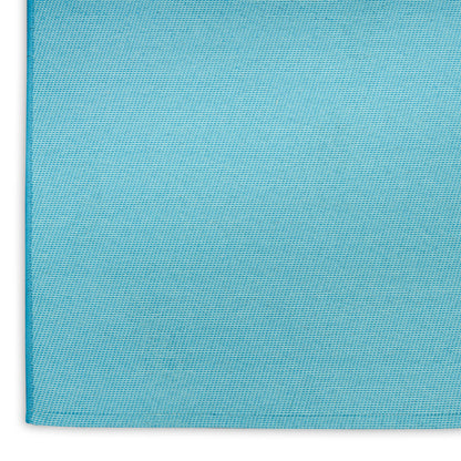 Turquoise blue rug close-up with visible weave and edge seam; suitable for coastal decor.