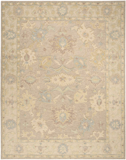 Rectangular, antique-inspired pastel oriental rug with beige field, central medallion, & muted blue, cream, pink floral border.