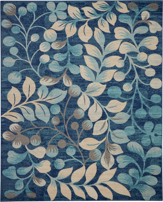 Blue area rug featuring cream and teal botanical leaves and berry clusters in a swirling vine pattern.