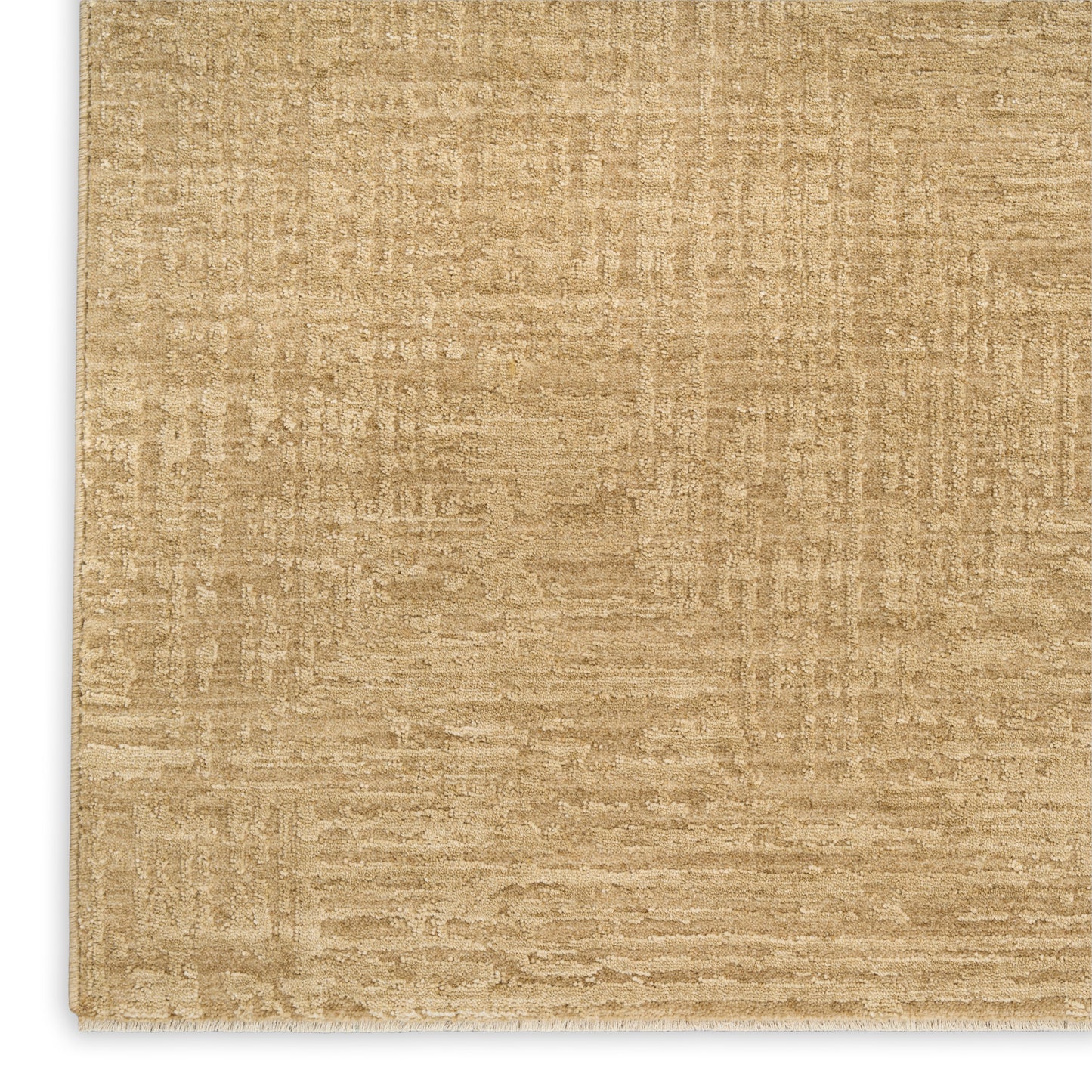 Beige textured rug close-up; flat-weave style in warm tan tones.