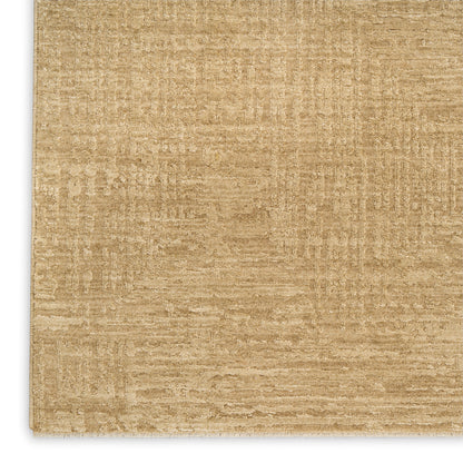 Beige textured rug close-up; flat-weave style in warm tan tones.