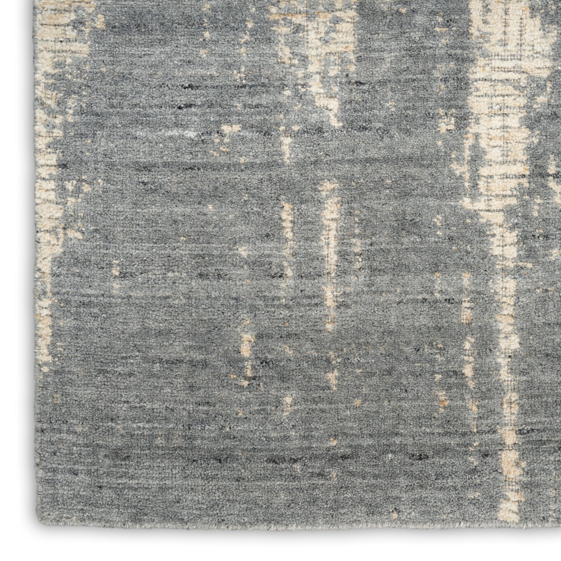 Rectangular blue-gray distressed rug with cream vertical streaks, woven low-pile texture, modern abstract design.