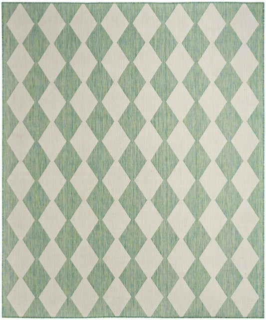 Mint-green woven rug with white diamond harlequin pattern and subtle striped texture.