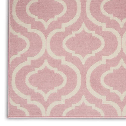Pink rug with cream-white trellis pattern, soft woven texture, decorative geometric floor covering.