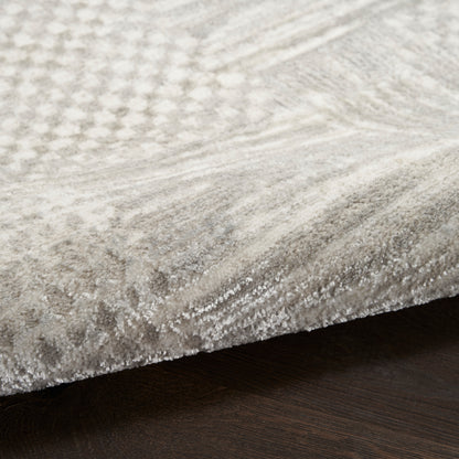 Soft light gray runner rug with subtle geometric pattern and dense plush pile on dark wood floor, 8' long.