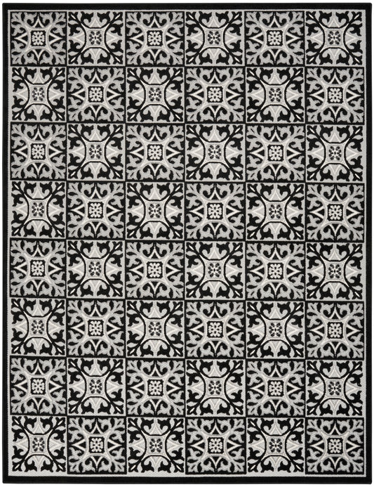 Black-and-ivory area rug with a grid of ornate tile motifs and a dark border.