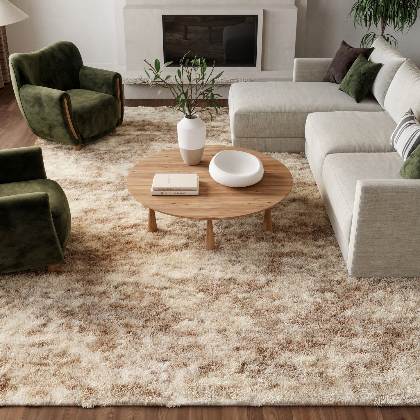 Cozy living room with beige shag rug, round wood coffee table, white vase, beige sectional, and green velvet chairs.