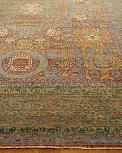 Rectangular wool rug with oriental medallion motifs, blue, red, gold and green tones; intricate borders and fringe.