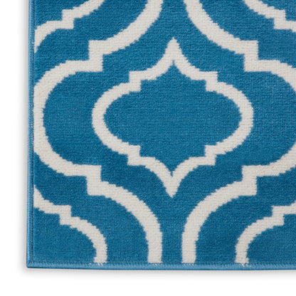 Blue rug with white Moroccan trellis geometric pattern; plush textile, modern decor.
