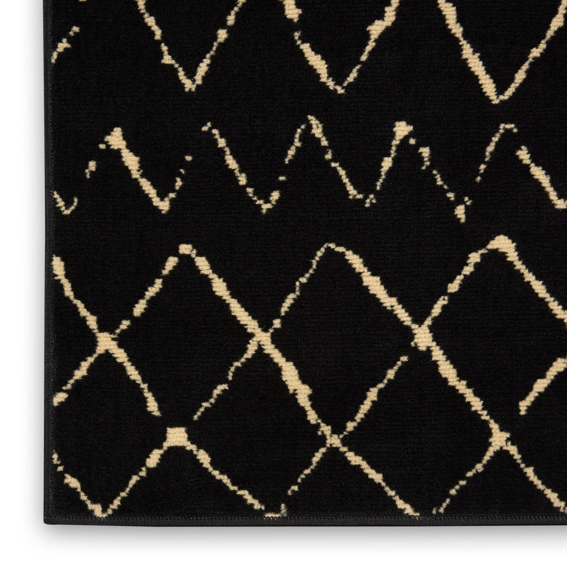 Black rectangular Bohemian-style rug, 3' x 5', with cream diamond lattice pattern and soft textured pile.