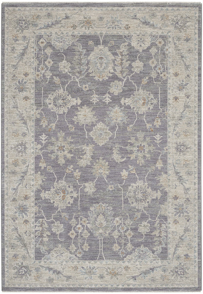 Lavender-gray oriental rug with ivory floral medallions and a light beige border.