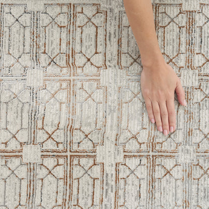Hand resting on textured beige rug with brown geometric lattice pattern.