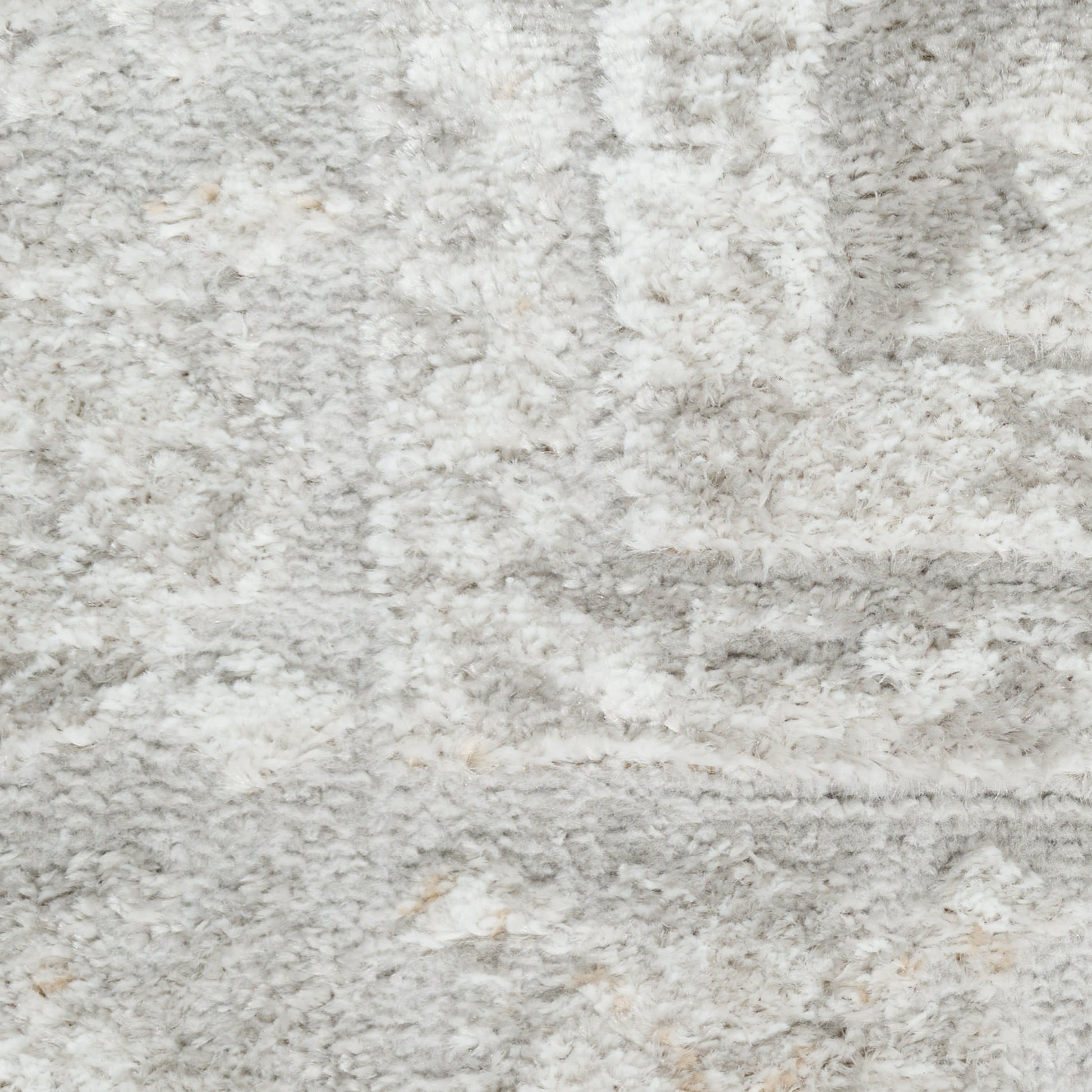 Light gray and white shag rug with plush pile and subtle abstract pattern.