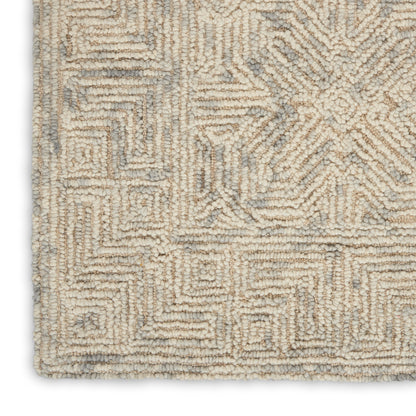 Cream-beige boucle rug with light gray geometric maze pattern and plush textured pile.