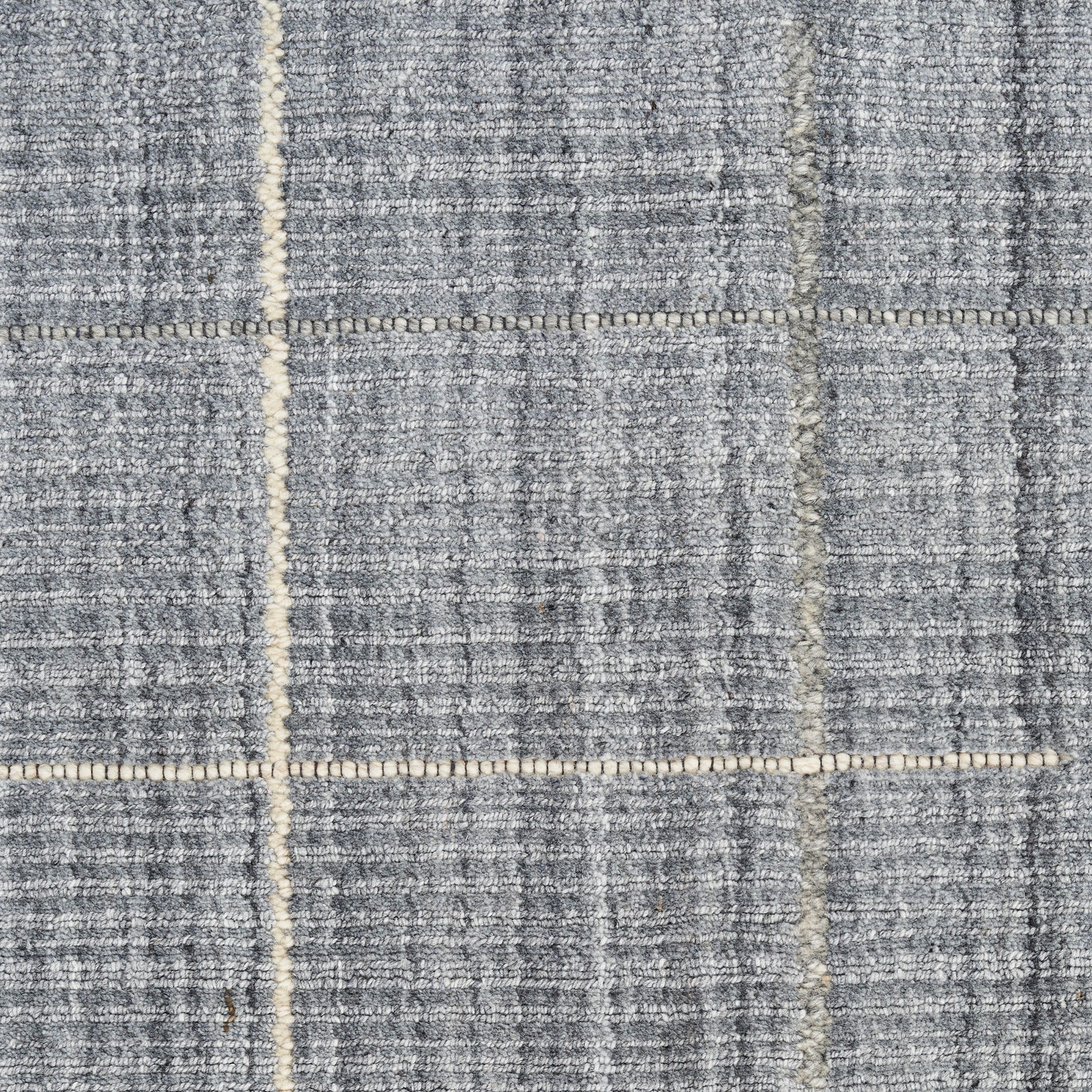 Gray woven rug with cream grid lines; textured plaid-inspired floor covering.
