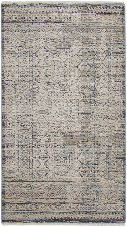Rectangular distressed geometric rug in muted blues and grays with beige accents; woven tribal pattern for living room.