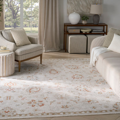 Bright neutral living room with cream sofa and armchair, light floral area rug, and a wooden console shelf with decor.