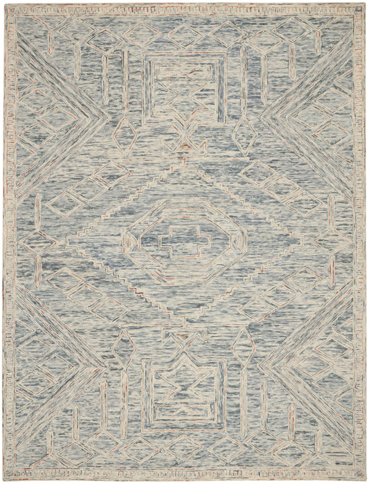 Blue-gray area rug with cream geometric medallions and peach accents in a distressed, vintage-inspired tribal pattern.