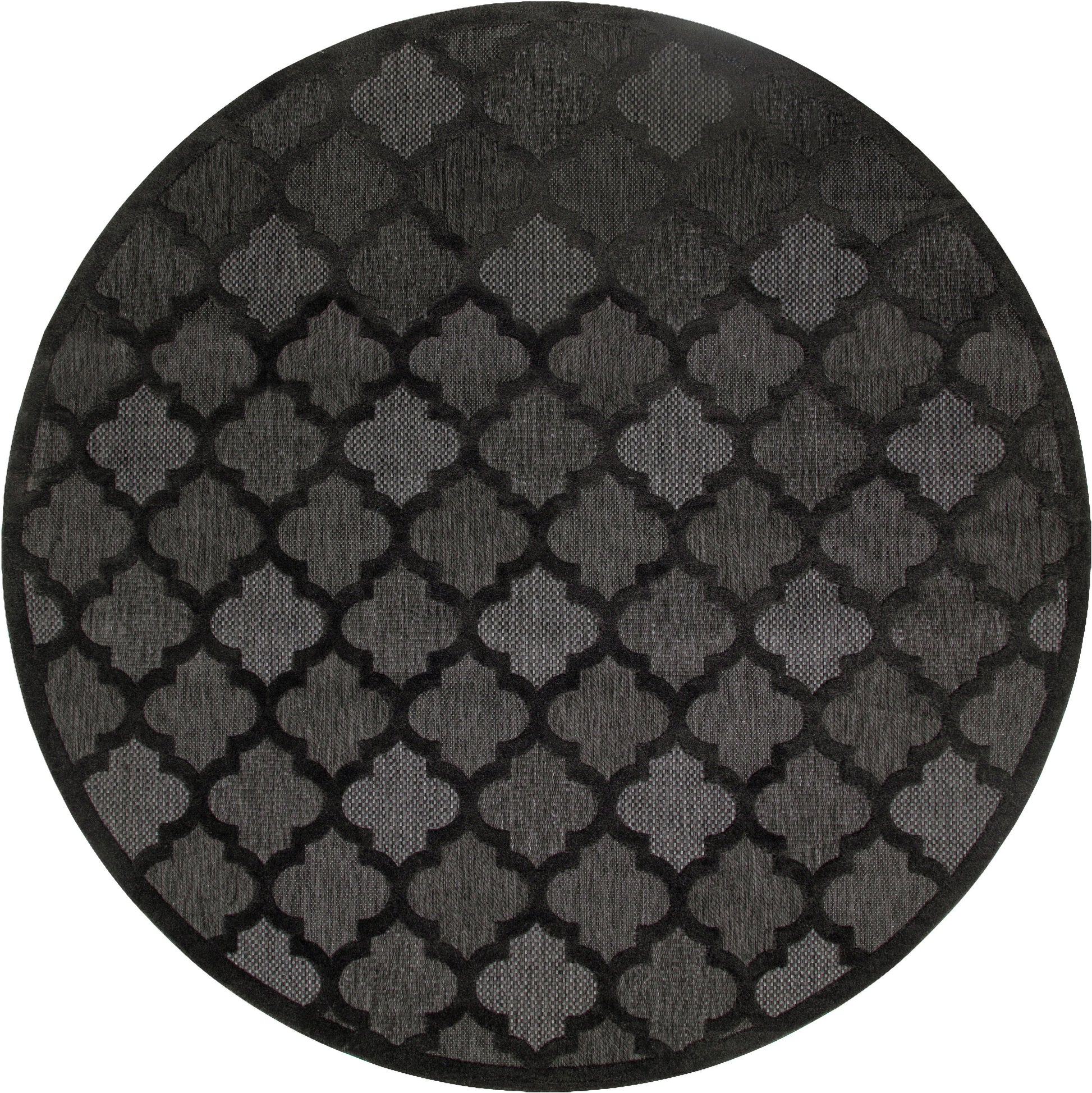 Round charcoal rug with a repeating black quatrefoil lattice pattern, plush textile.