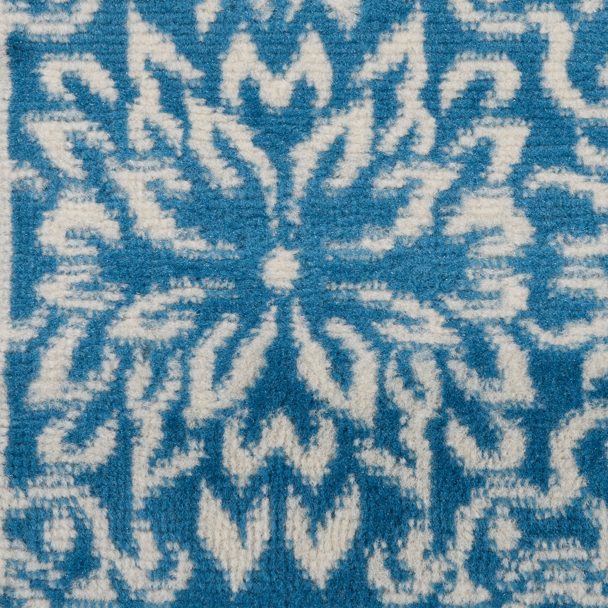 Pale blue rectangular panel with smooth matte finish on blue patterned rug.