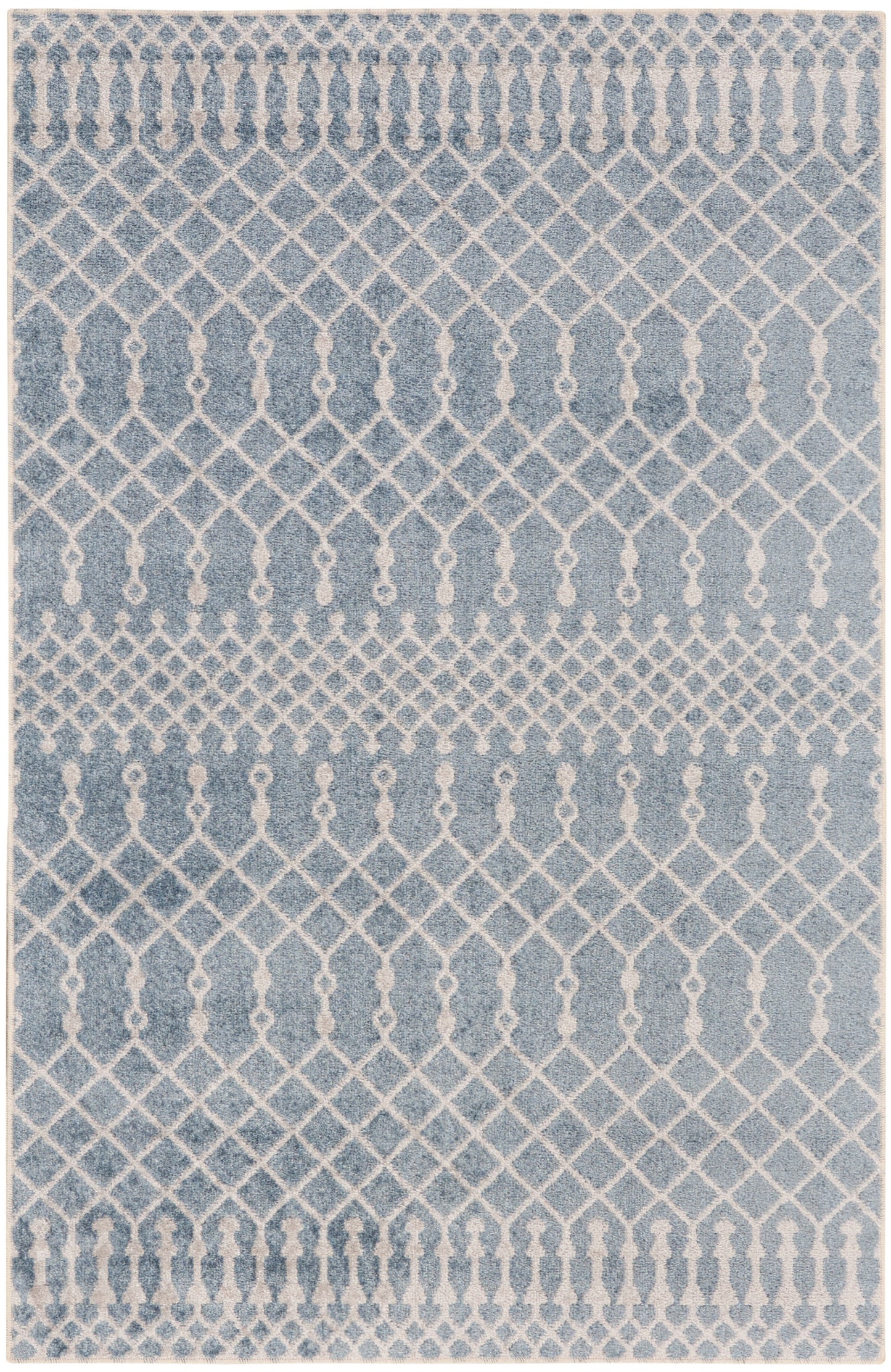 Blue rug with ivory lattice and diamond trellis pattern; distressed finish for contemporary living room decor.